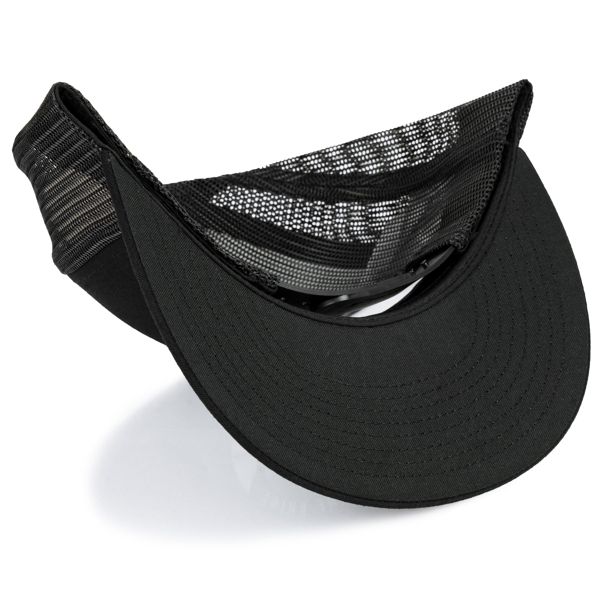 Dark camo snapback trucker hat with black mesh back and curved brim
