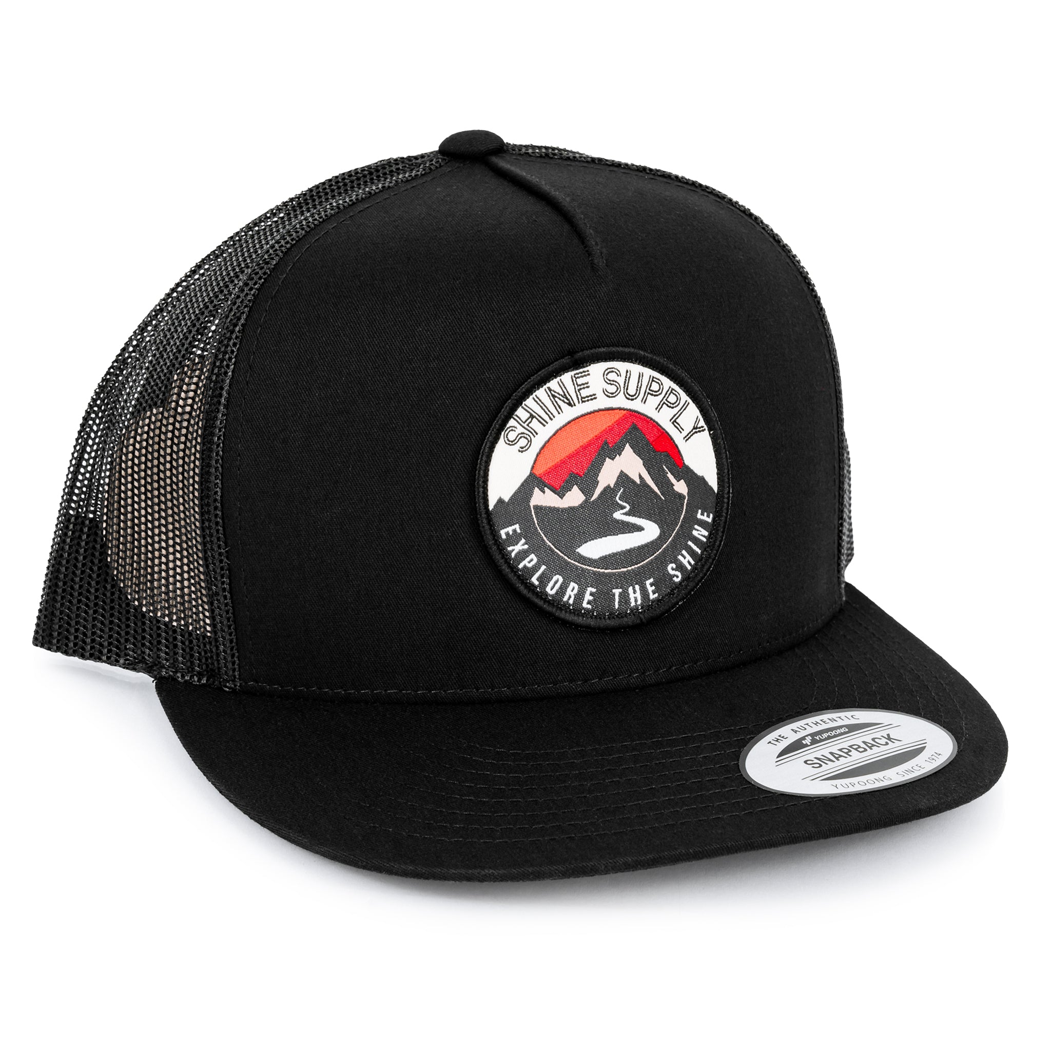 Black trucker snapback hat with mesh back and circular "Shine Supply Explore The Shine" logo