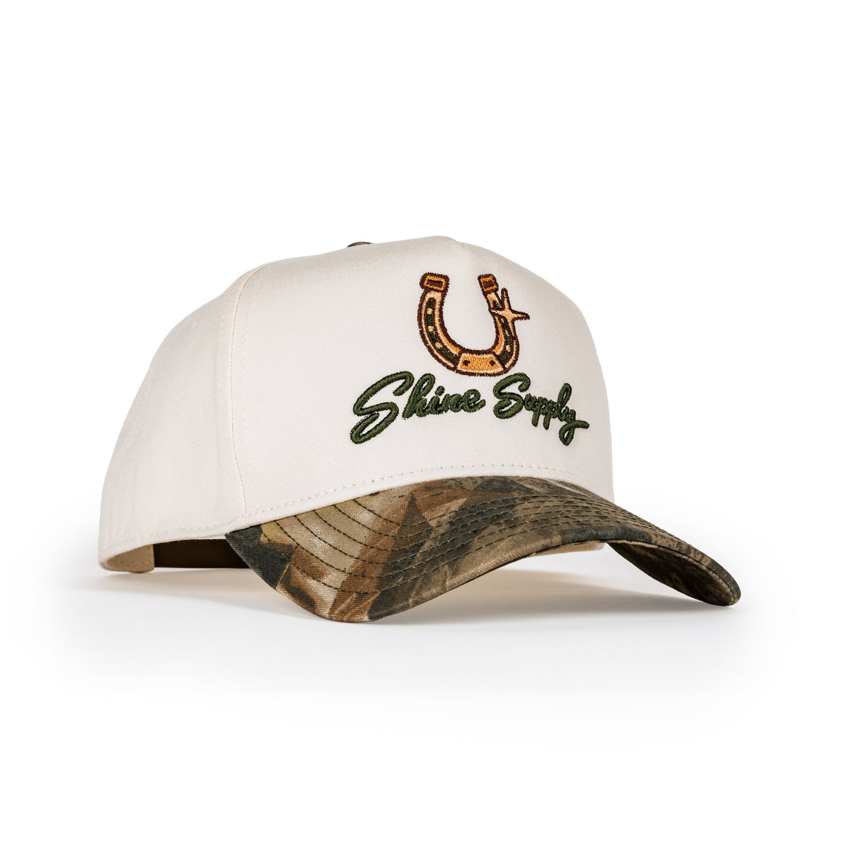 Saddle Up snapback in cream with camo bill, embroidered gold horseshoe and Shine Supply script