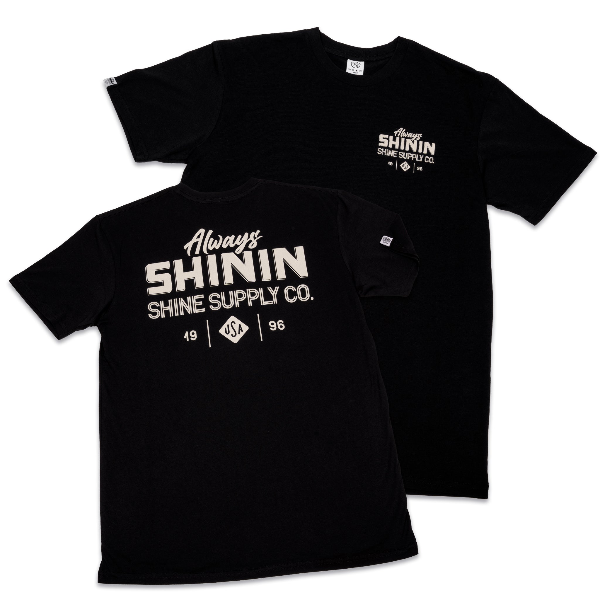 Two black t-shirts displaying 'Always Shinin Shine Supply Co.' logo in white text; one has a small chest logo, another large across the front.